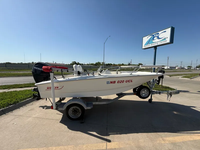 Slide: The Image of 2009 Boston Whaler 130 Super Sport boat on trailer, parked outdoors. - 5