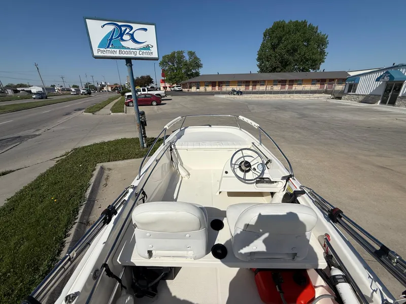 Slide: The Image of 2009 Boston Whaler 130 Super Sport boat at Premier Boating Center parking lot. - 6