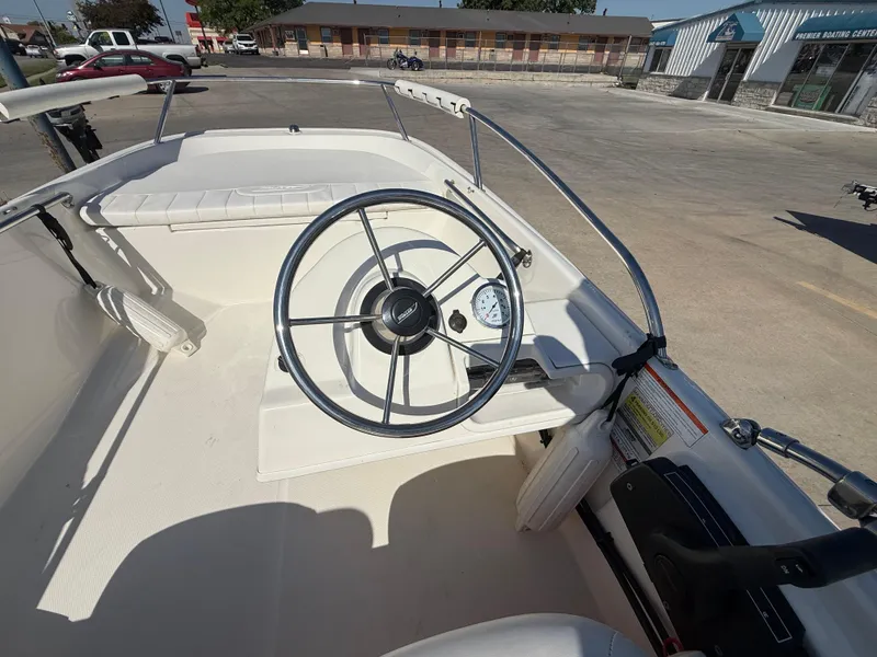 Slide: The Image of 2009 Boston Whaler 130 Super Sport boat interior with steering wheel and dashboard. - 7