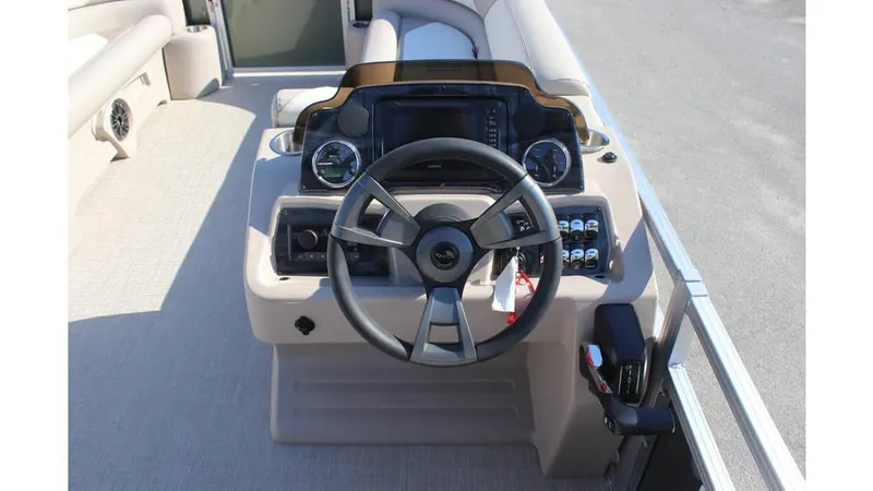 Slide: The Image of 2025 Tahoe Sport 85 Rear Fish 23 SW boat dashboard with steering wheel and controls. - 11