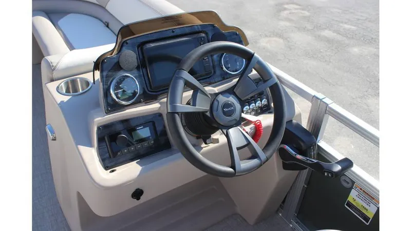 Slide: The Image of 2025 Tahoe Sport 85 Rear Fish 23 SW boat dashboard with steering wheel and controls. - 12