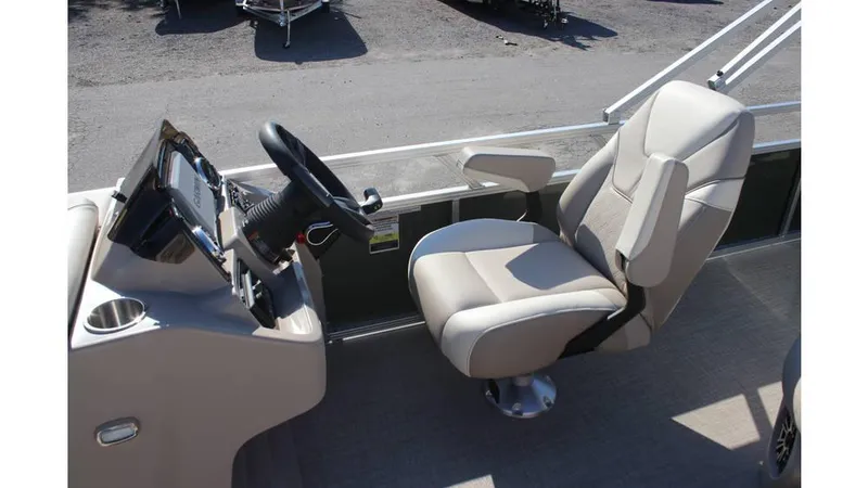 Slide: The Image of 2025 Tahoe Sport 85 Rear Fish 23 SW boat interior with steering wheel and captain's chair. - 13