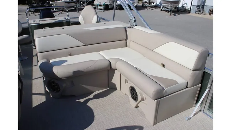 Slide: The Image of 2025 Tahoe Sport 85 Rear Fish 23 SW boat interior with beige seating and speakers. - 14