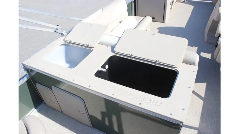 Slide: The Image of 2025 Tahoe Sport 85 Rear Fish 23 SW boat interior with storage compartments open. - 18