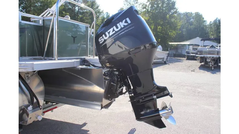 Slide: The Image of 2025 Tahoe Sport 85 Rear Fish 23 SW with Suzuki outboard motor in a sunny outdoor setting. - 9