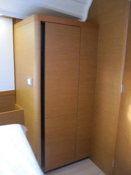 Slide: The Image of 2024 Jeanneau Sun Odyssey 410 interior with wooden cabinetry. - 12