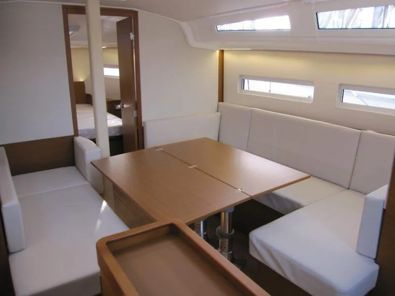 Slide: The Image of 2024 Jeanneau Sun Odyssey 410 interior with modern seating and dining area. - 14