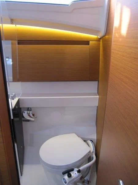 Slide: The Image of 2024 Jeanneau Sun Odyssey 410 yacht bathroom with modern fixtures and wood accents. - 17