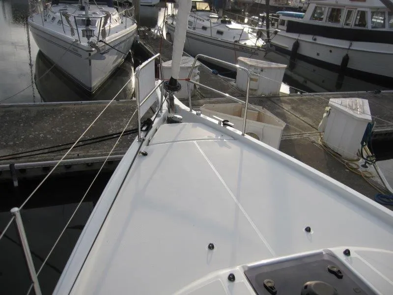 Slide: The Image of 2024 Jeanneau Sun Odyssey 410 yacht docked at marina, showcasing sleek deck design. - 33