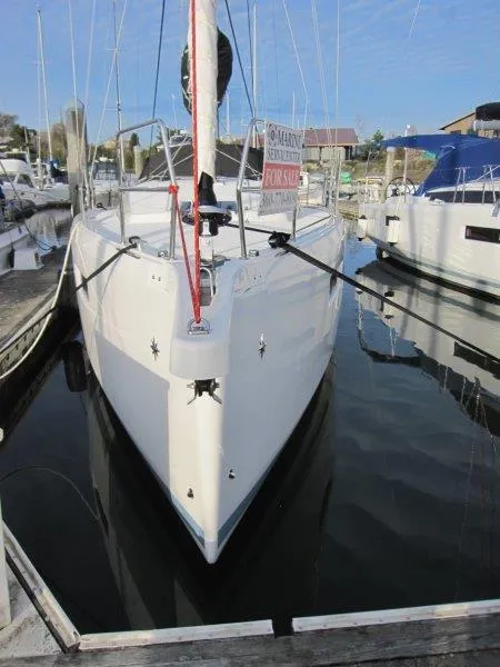 Slide: The Image of 2024 Jeanneau Sun Odyssey 410 sailboat docked, front view, with "For Sale" sign. - 43