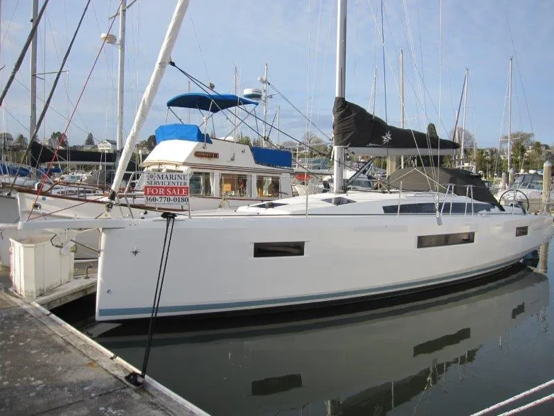 Slide: The Image of 2024 Jeanneau Sun Odyssey 410 sailboat docked, with "For Sale" sign visible. - 44