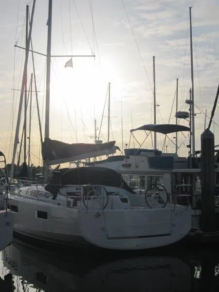 Slide: The Image of 2024 Jeanneau Sun Odyssey 410 sailboat docked at sunset. - 46