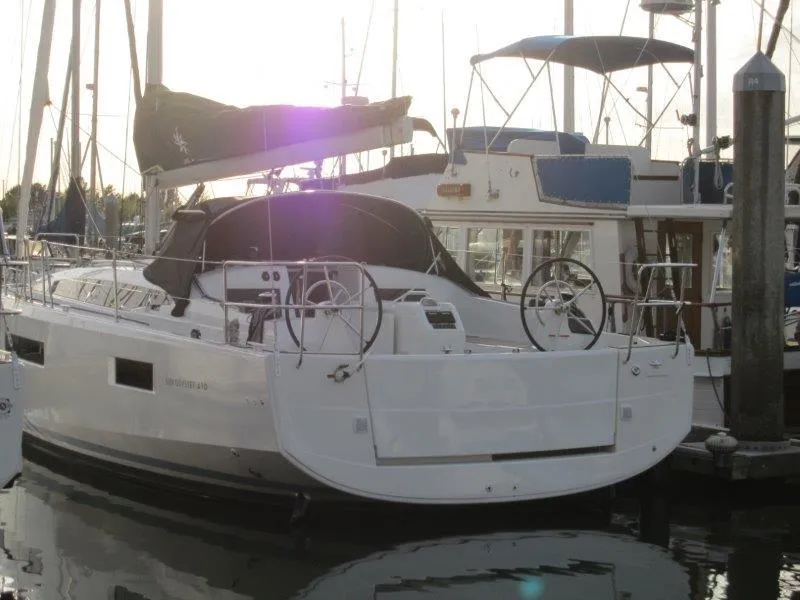 Slide: The Image of 2024 Jeanneau Sun Odyssey 410 sailboat docked in marina, rear view. - 47