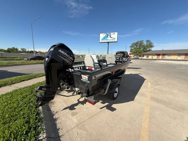 Slide: The Image of 2012 Crestliner Kodiak 16 boat with Mercury engine parked outdoors on a sunny day. - 4