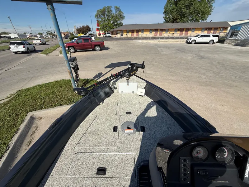 Slide: The Image of 2012 Crestliner Kodiak 16 boat parked in a lot, featuring a trolling motor. - 8