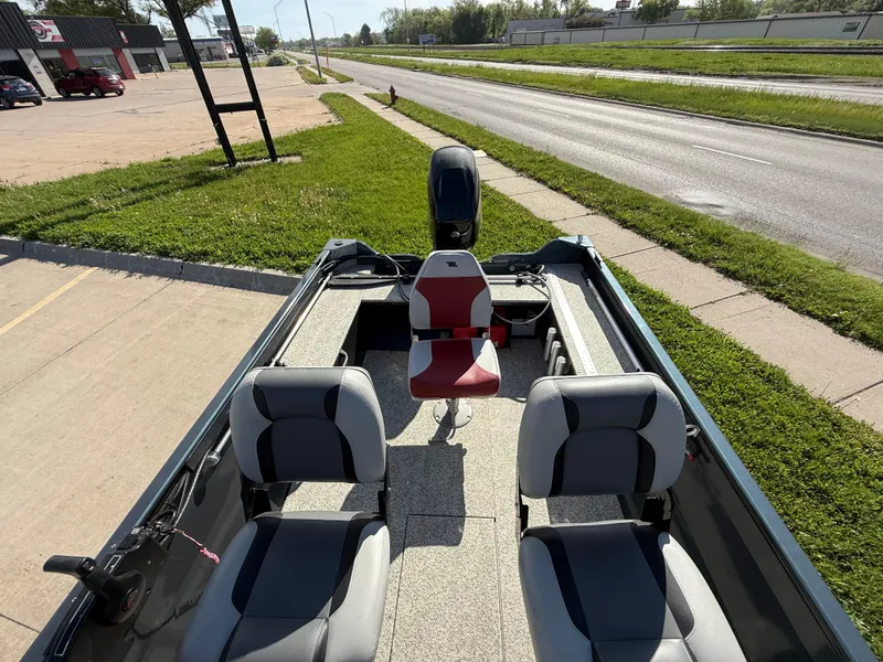 Slide: The Image of 2012 Crestliner Kodiak 16 boat with three seats, parked near a road. - 9