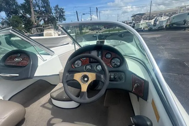 Slide: The Image of 2002 Triton 190-FS boat dashboard with steering wheel and instrument panel. - 12
