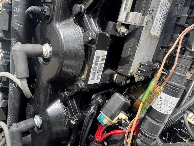 Slide: The Image of Close-up of a 2002 Triton 190-FS engine with visible wiring and components. - 17