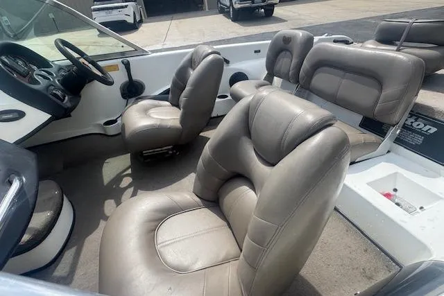 Slide: The Image of 2002 Triton 190-FS boat interior with gray leather seats and steering wheel. - 8