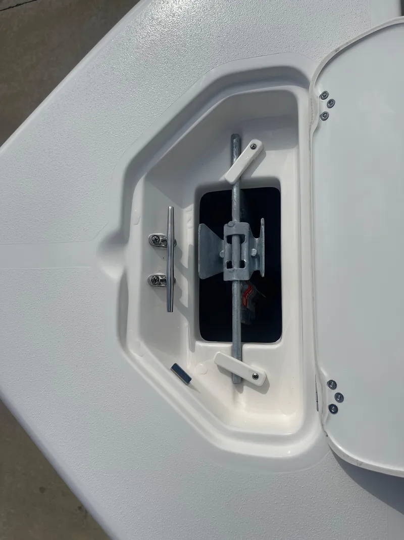 Slide: The Image of 2025 Key West 179 FS boat anchor locker with open hatch and securing hardware. - 13