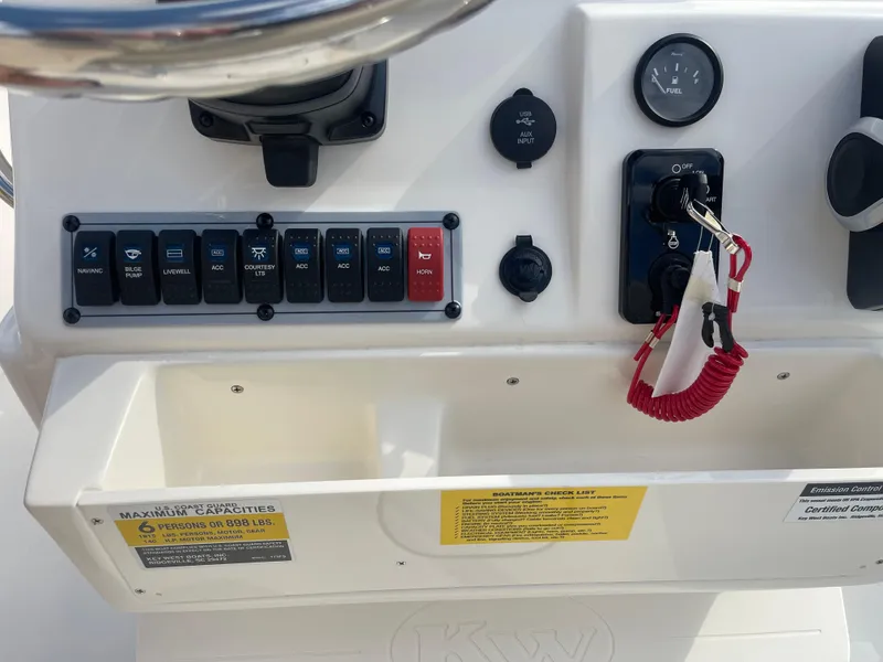 Slide: The Image of Control panel of 2025 Key West 179 FS boat with switches and ignition keys. - 25