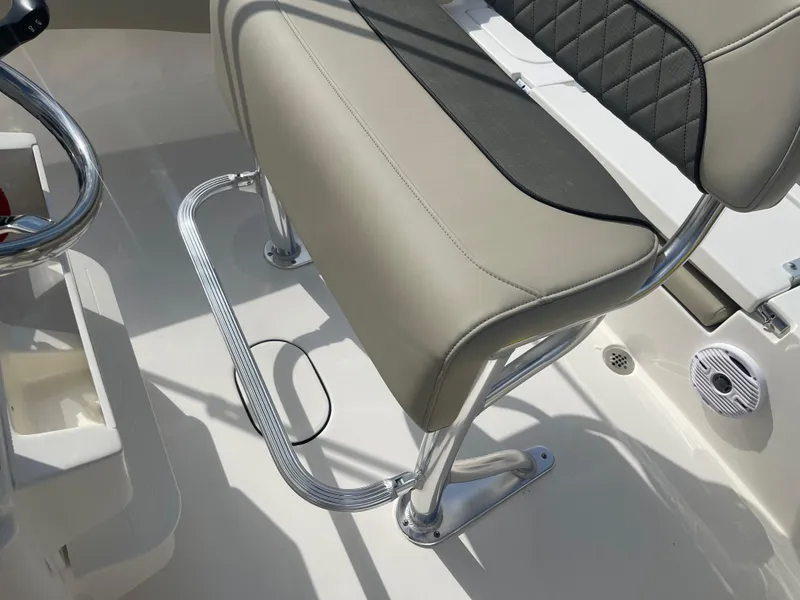 Slide: The Image of 2025 Key West 179 FS boat seat with chrome footrest and beige upholstery. - 31