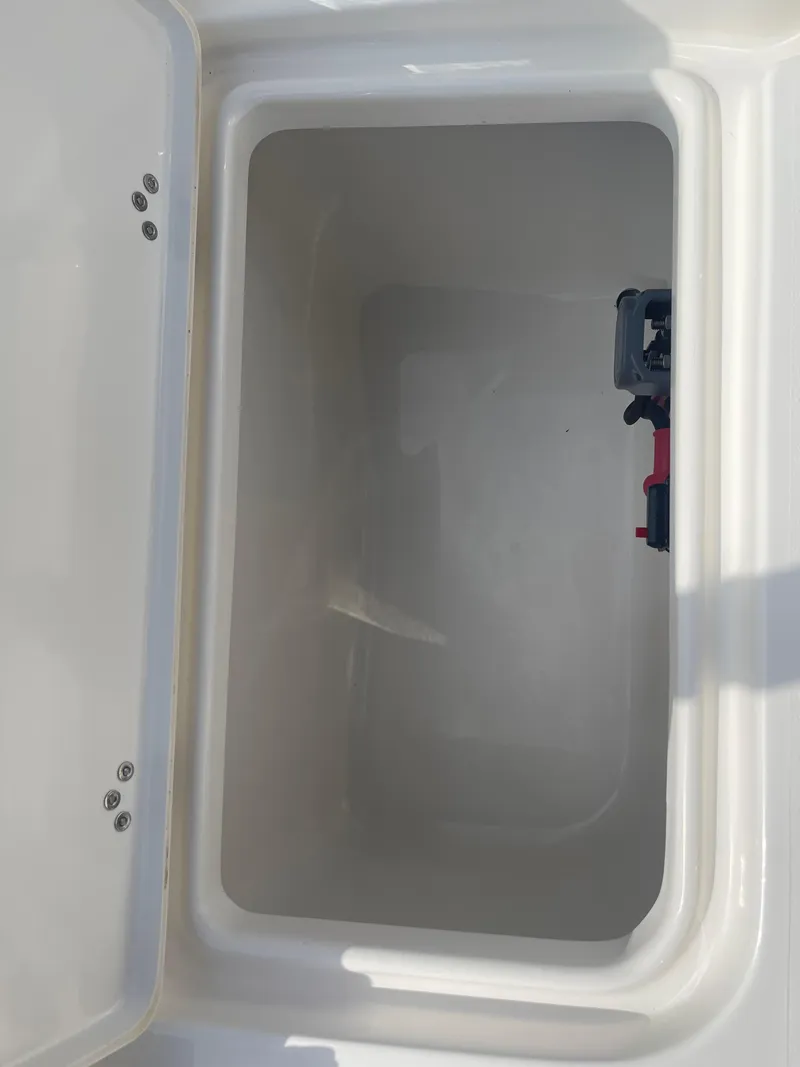 Slide: The Image of 2025 Key West 179 FS boat storage compartment, open lid, spacious interior. - 38