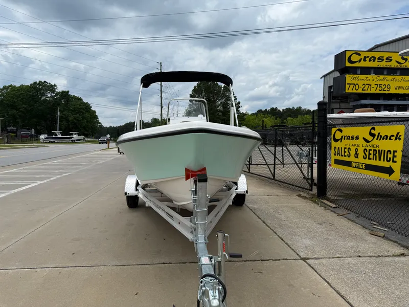 Slide: The Image of 2025 Key West 179 FS boat on trailer, parked near sales and service shop. - 4