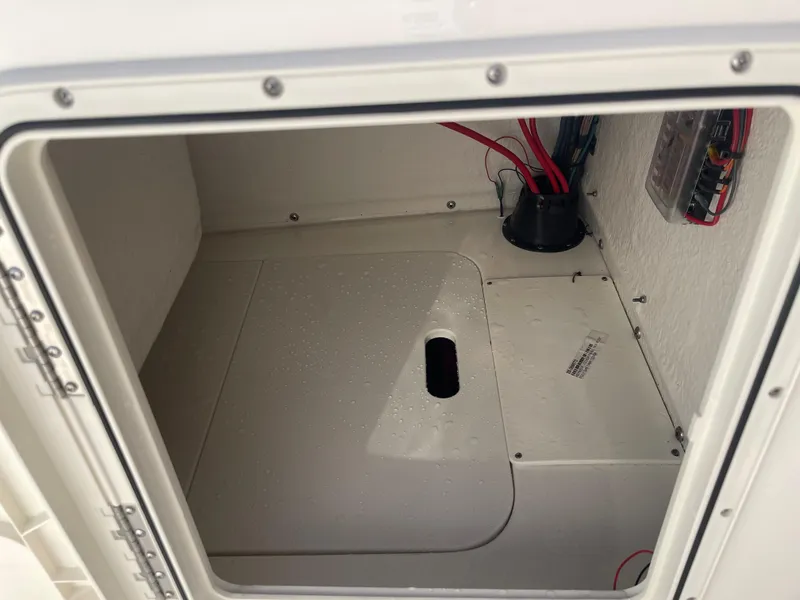 Slide: The Image of 2025 Key West 179 FS boat storage compartment with wiring and fuse panel. - 41