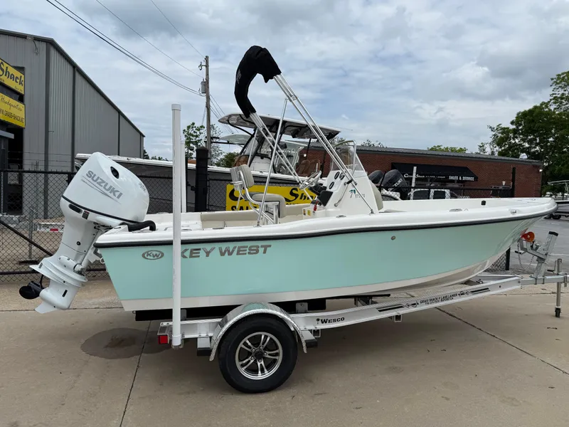 Slide: The Image of 2025 Key West 179 FS boat on trailer with Suzuki outboard motor, parked outdoors. - 7