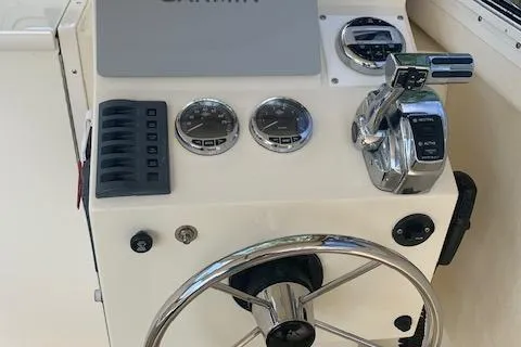 Slide: The Image of Control panel of a 2011 Eastern 24 Explorer boat with steering wheel and gauges. - 10