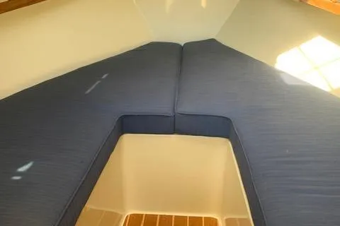 Slide: The Image of Interior view of 2011 Eastern 24 Explorer boat with blue cushioned seating. - 11