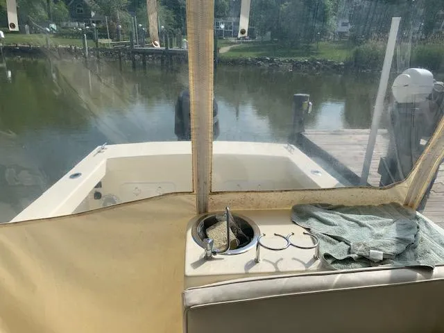 Slide: The Image of Interior view of a 2011 Eastern 24 Explorer boat docked by a calm waterfront. - 5