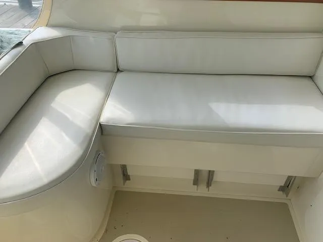 Slide: The Image of 2011 Eastern 24 Explorer boat interior with white cushioned seating. - 7