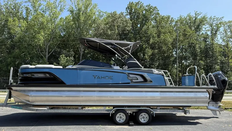 The Image of 2025 Tahoe Pontoon Grand Tahoe Elite Windshield on trailer, parked outdoors. - 0
