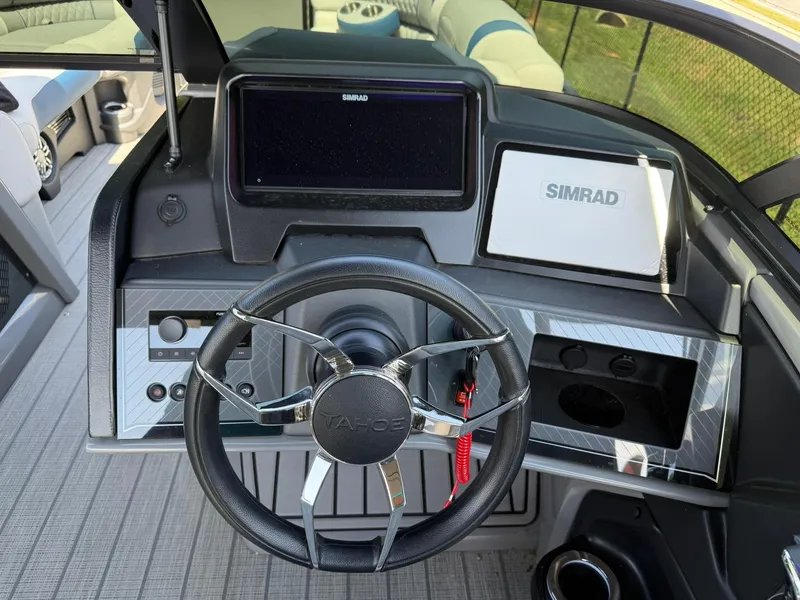 Slide: The Image of 2025 Tahoe Pontoon Grand Tahoe Elite dashboard with steering wheel and Simrad display. - 10