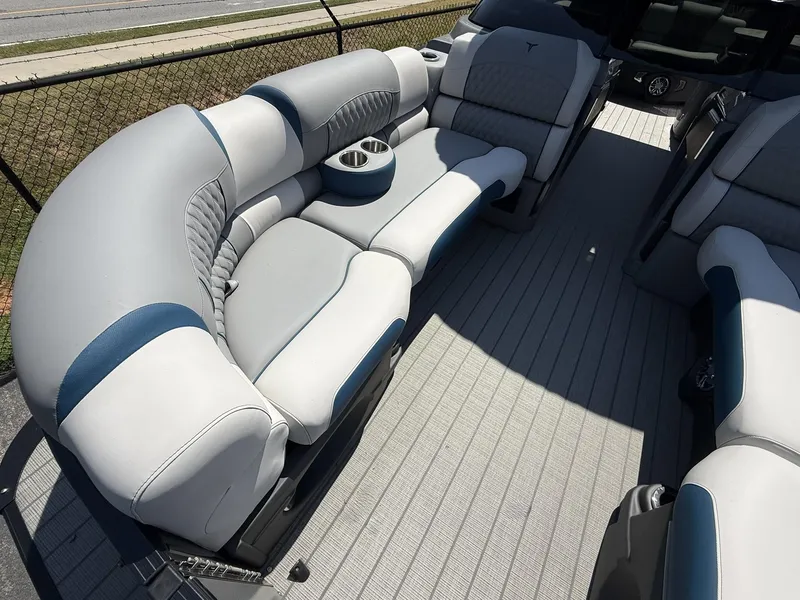 Slide: The Image of 2025 Tahoe Pontoon Grand Tahoe Elite Windshield interior with luxurious seating and cup holders. - 12