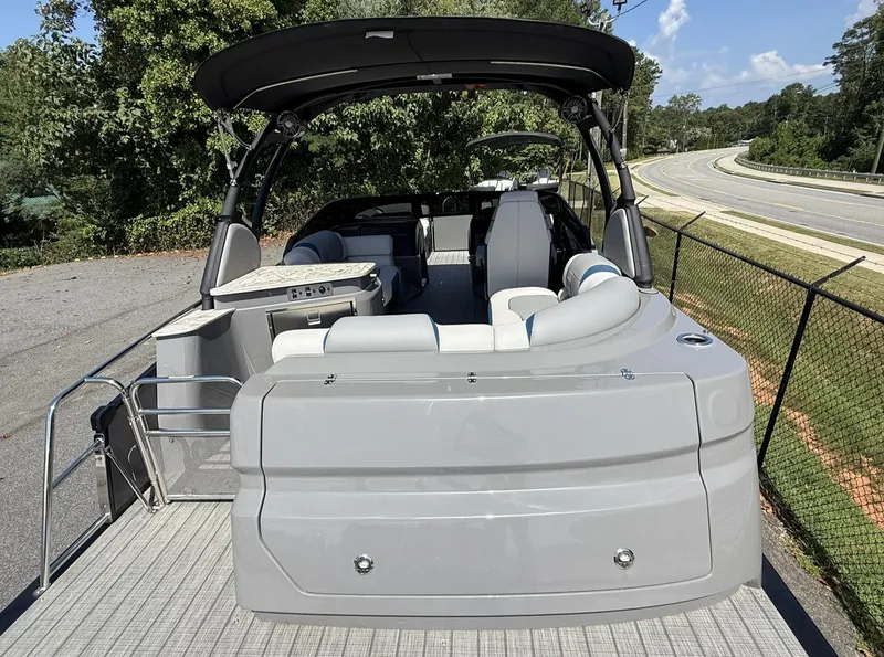 Slide: The Image of 2025 Tahoe Pontoon Grand Tahoe Elite Windshield, rear view, parked on a sunny day. - 16