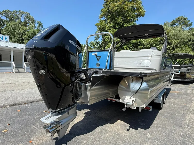 Slide: The Image of 2025 Tahoe Pontoon Grand Tahoe Elite Windshield with Mercury outboard engine, parked outdoors. - 4
