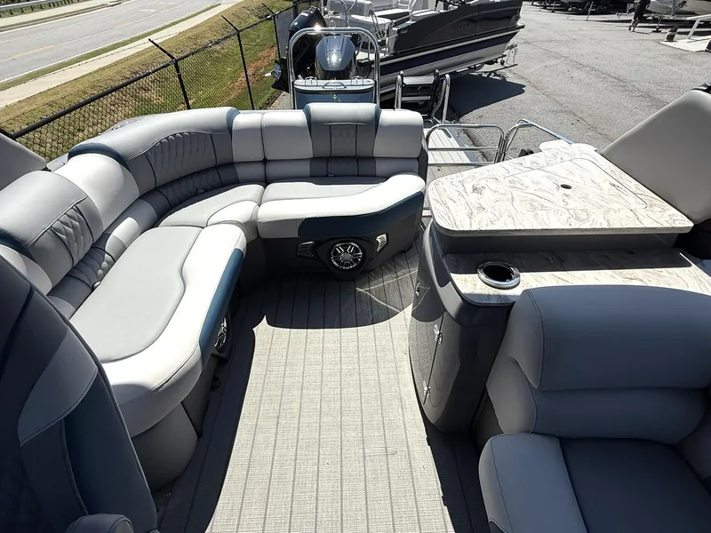 Slide: The Image of 2025 Tahoe Pontoon Grand Tahoe Elite Windshield interior with luxurious seating and table. - 7