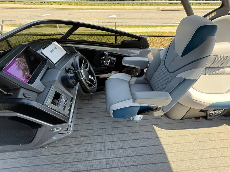 Slide: The Image of 2025 Tahoe Pontoon Grand Tahoe Elite Windshield helm with modern controls and luxurious seating. - 9