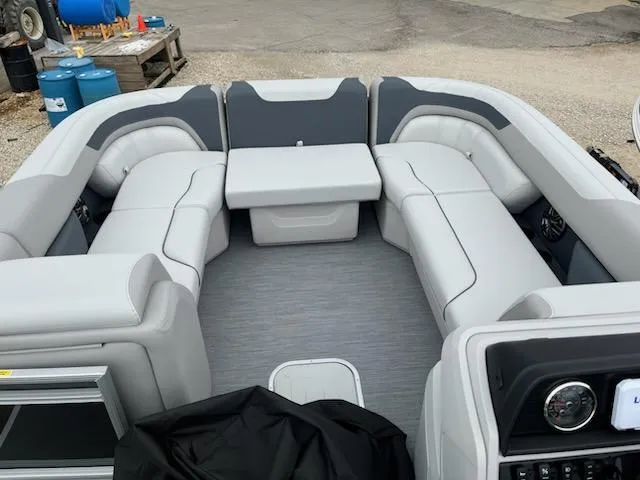 Slide: The Image of 2025 Sweetwater 2286SFL boat interior with gray seating and modern dashboard. - 19