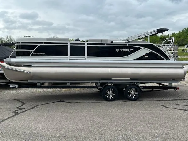 Slide: The Image of 2025 Sweetwater 2286SFL pontoon boat on trailer, side view, overcast sky. - 5