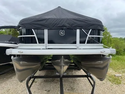 Slide: The Image of 2025 Sweetwater 2286SFL pontoon boat with black cover, parked on a trailer. - 7