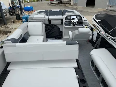Slide: The Image of 2025 Sweetwater 2286SFL pontoon boat interior with modern seating and steering console. - 9