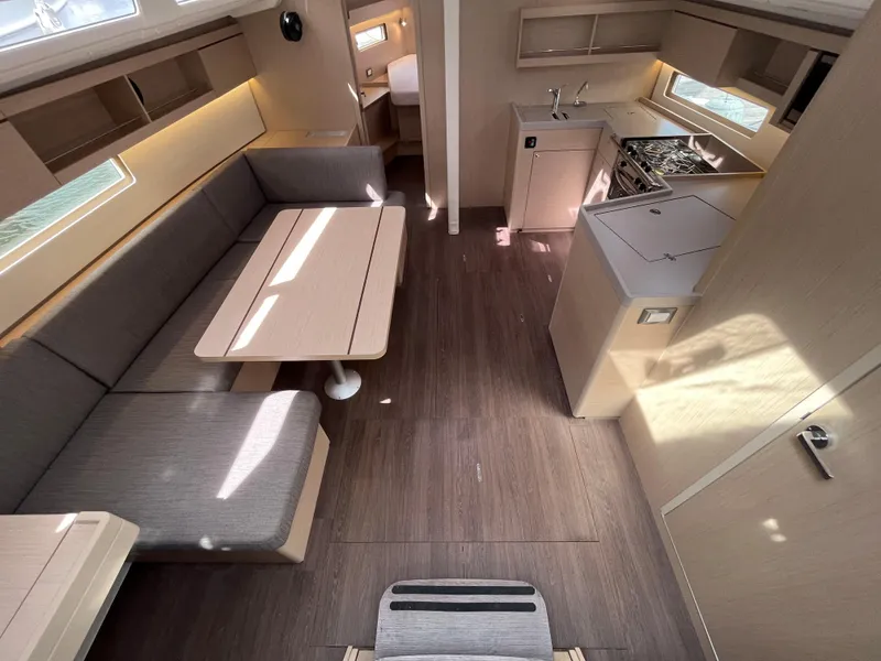 Slide: The Image of Modern interior of 2023 Beneteau Oceanis 40.1 yacht with kitchen and seating area. - 10