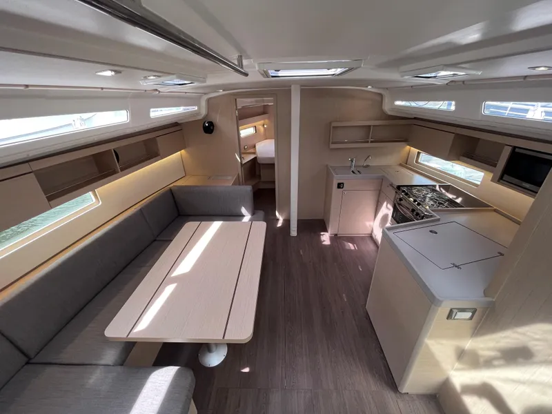 Slide: The Image of Interior of 2023 Beneteau Oceanis 40.1 yacht, featuring modern kitchen and seating area. - 12