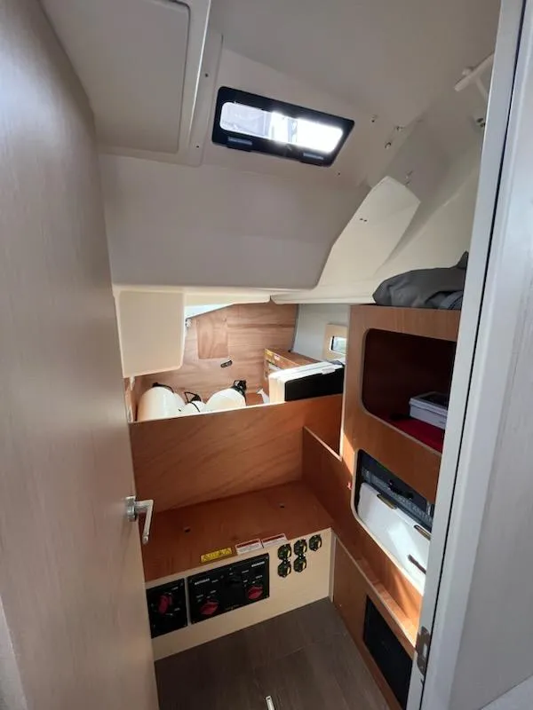 Slide: The Image of Interior of 2023 Beneteau Oceanis 40.1 sailboat, featuring modern wood finishes and compact design. - 17