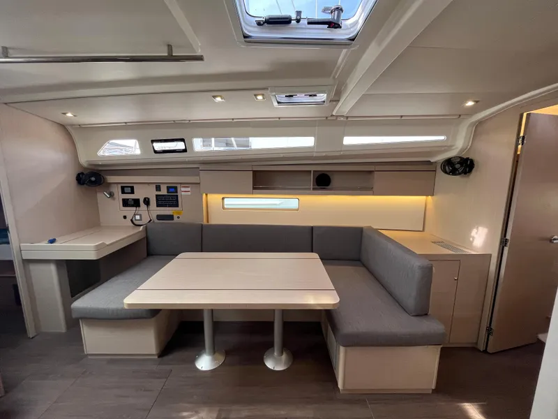 Slide: The Image of Interior of 2023 Beneteau Oceanis 40.1 yacht with modern seating and dining area. - 19