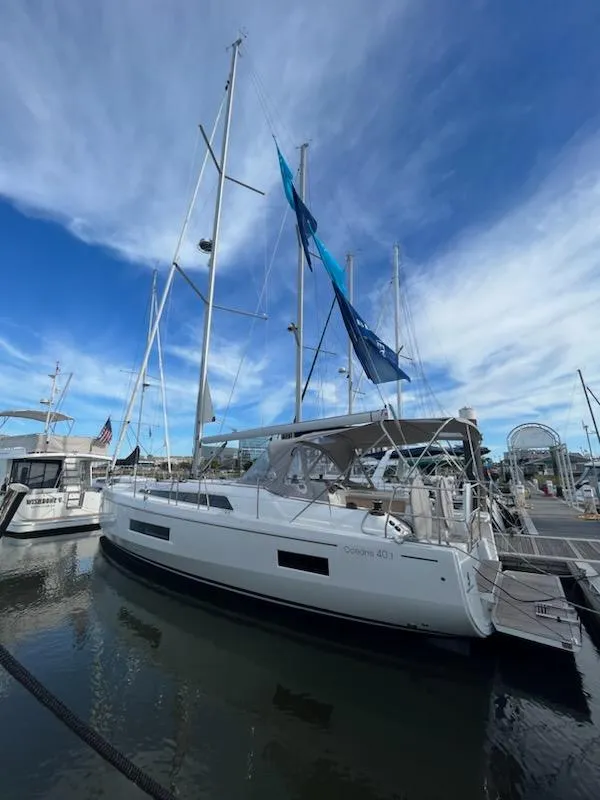 Slide: The Image of 2023 Beneteau Oceanis 40.1 sailboat docked under a vibrant blue sky. - 4